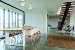 Domestic open space with dining table and wooden stairs